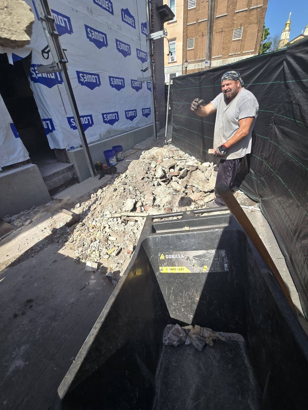TrueNorth Junk Solutions crew member clearing debris during a demo job