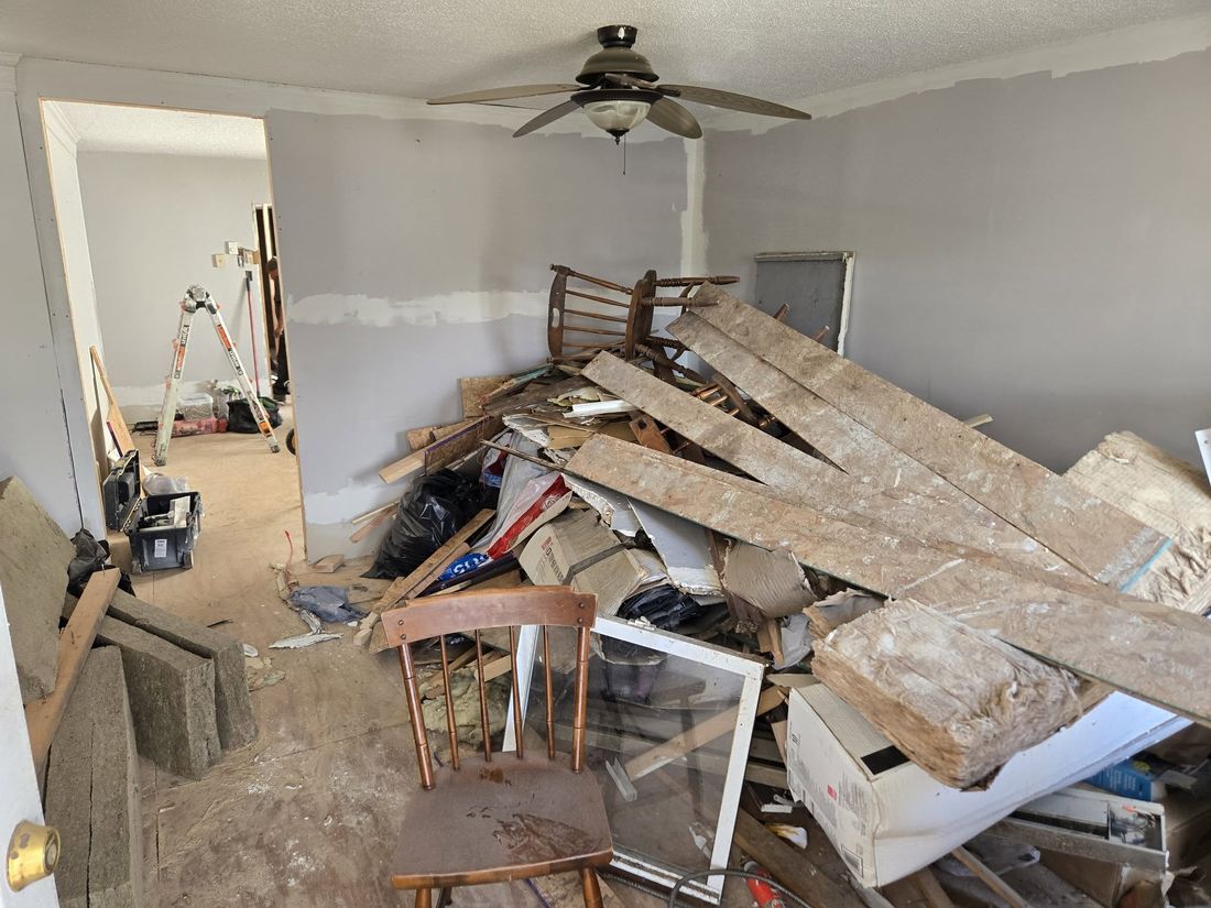 Cluttered room full of debris before cleanout